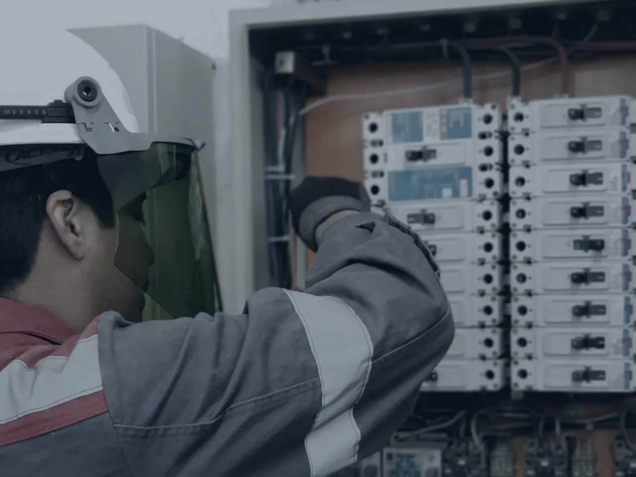 A technician working inside an electrical distribution board on site