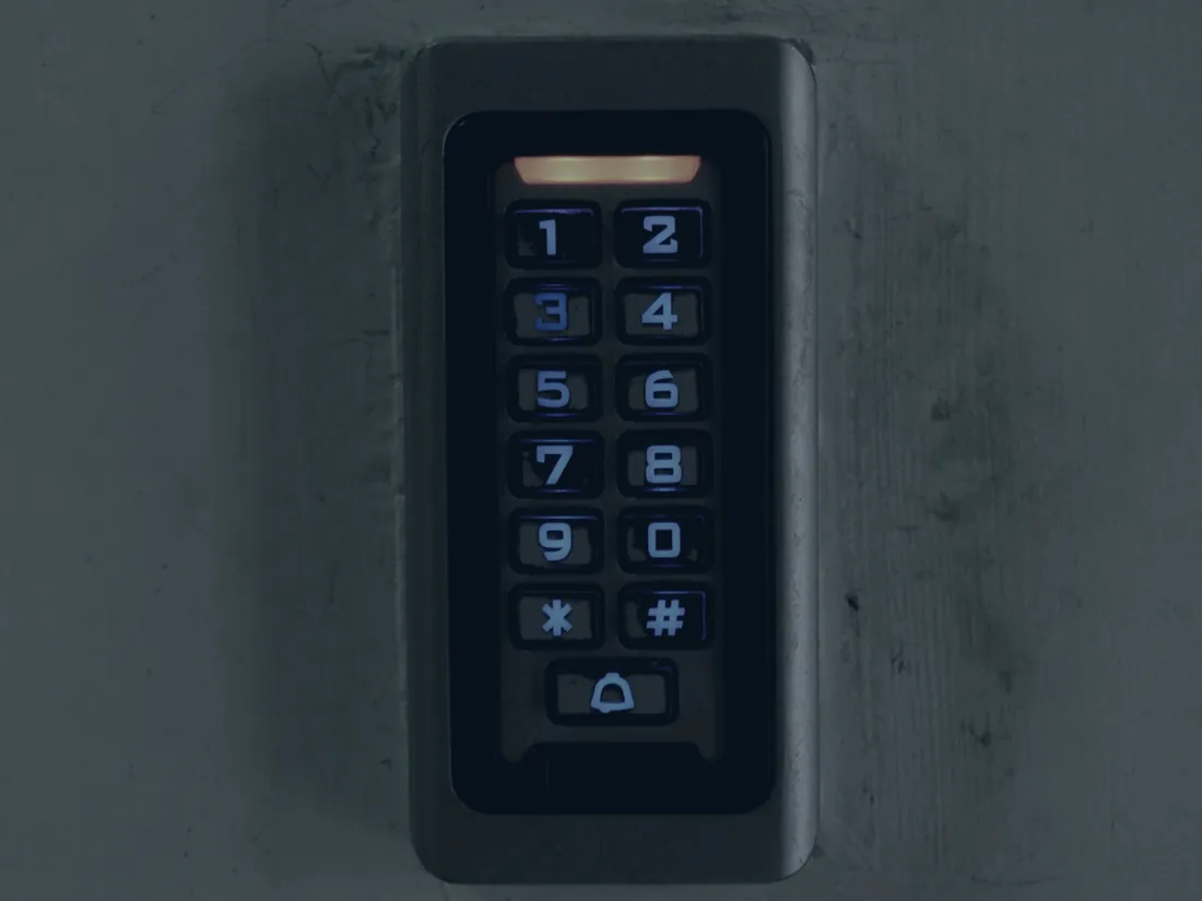 A keypad access control reader mounted on a concrete wall